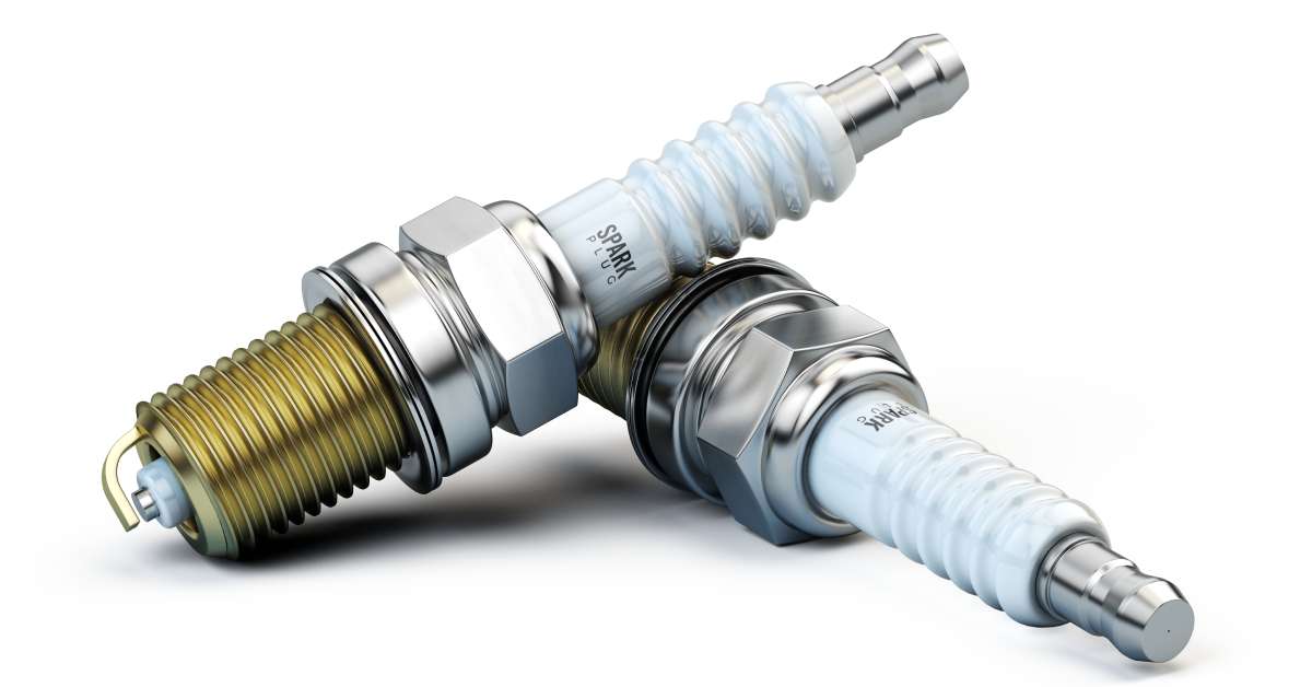 Two new automotive copper spark plugs displayed against a white background with one resting on top the other.